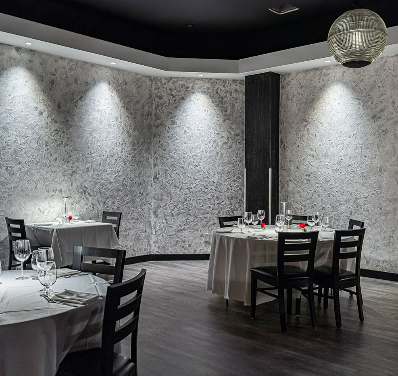Venetian plaster walls inside of a restaurant add texture to the room.